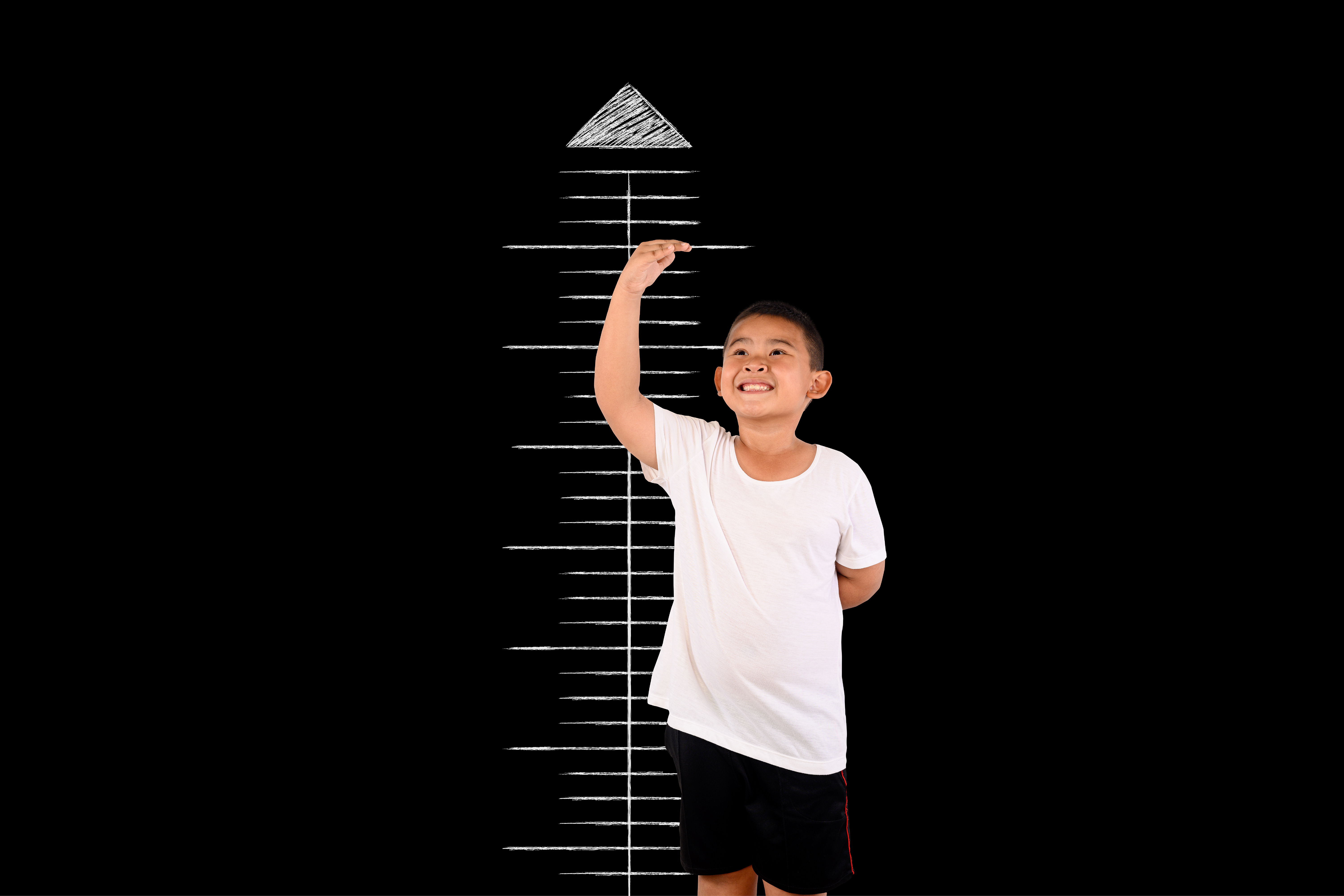 boy-measured-height-with-blackboard